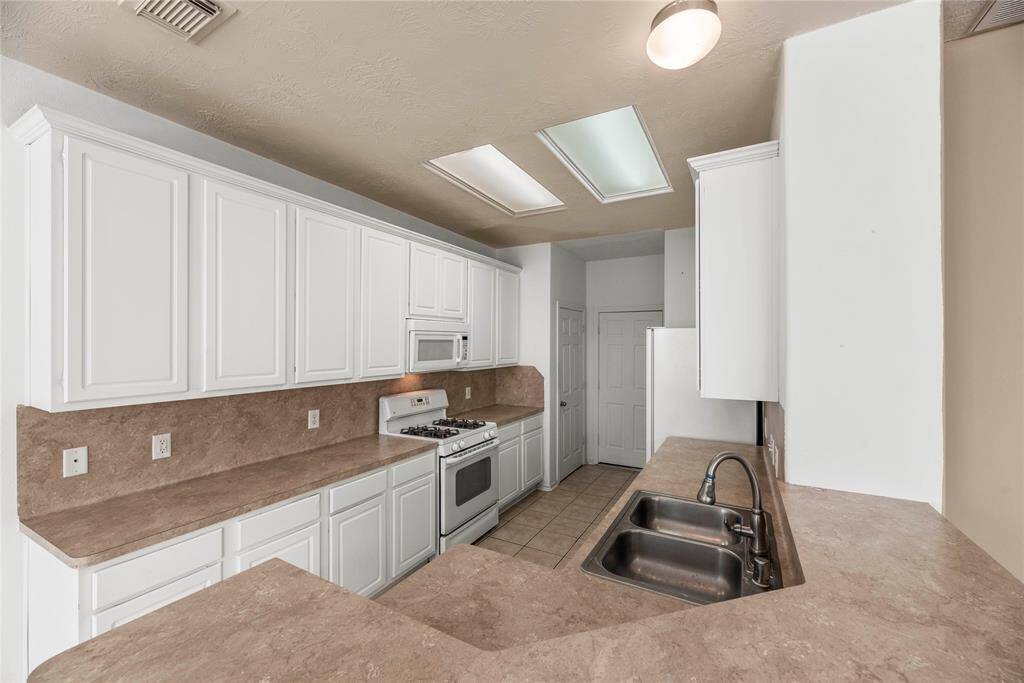 Crisp white cabinets provide a clean and timeless look, enhancing the sense of brightness and openness in this space.