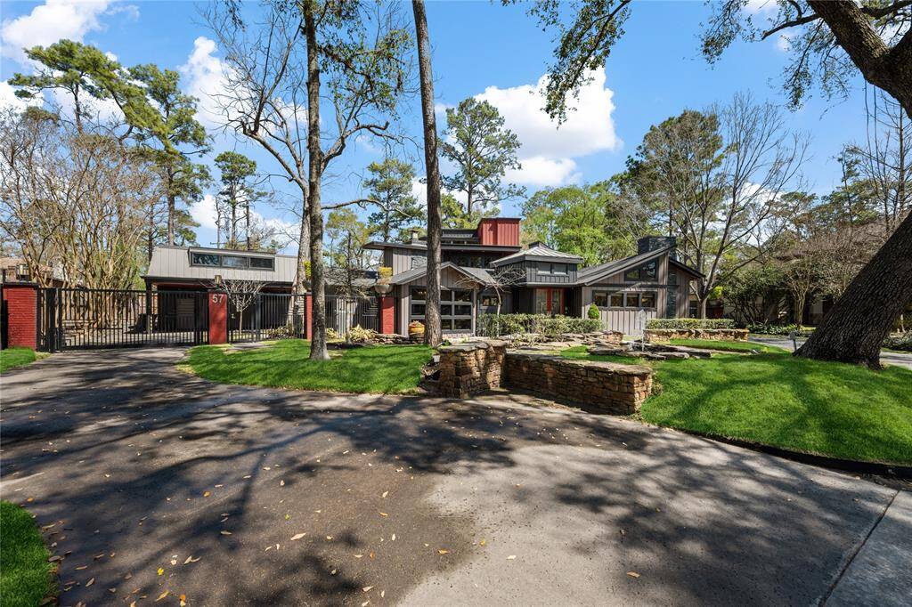 Redesigned with inspiration from Frank Lloyd Wright, this stunning home in Memorial Villages sits on an oversized, tree-filled lot with lush professional landscaping.