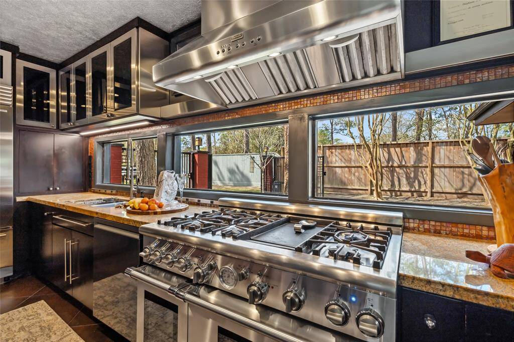 High-end appliance include a 6-burner range with a grill and double ovens.