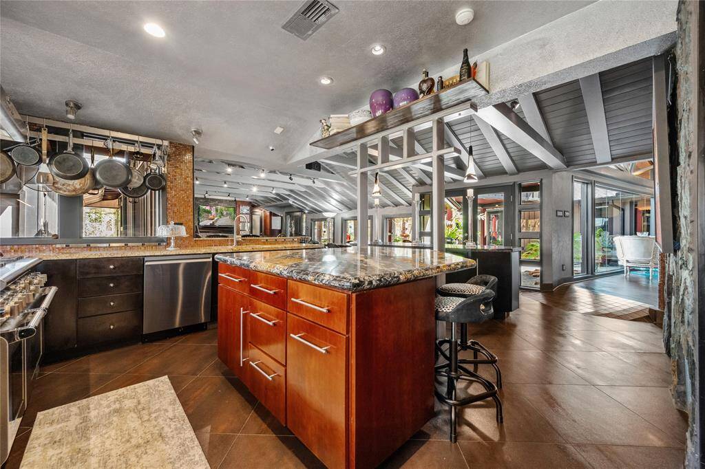 A spacious, open-concept kitchen designed for entertaining, featuring seamless flow to living and dining areas. It's the perfect space for gathering and hosting.