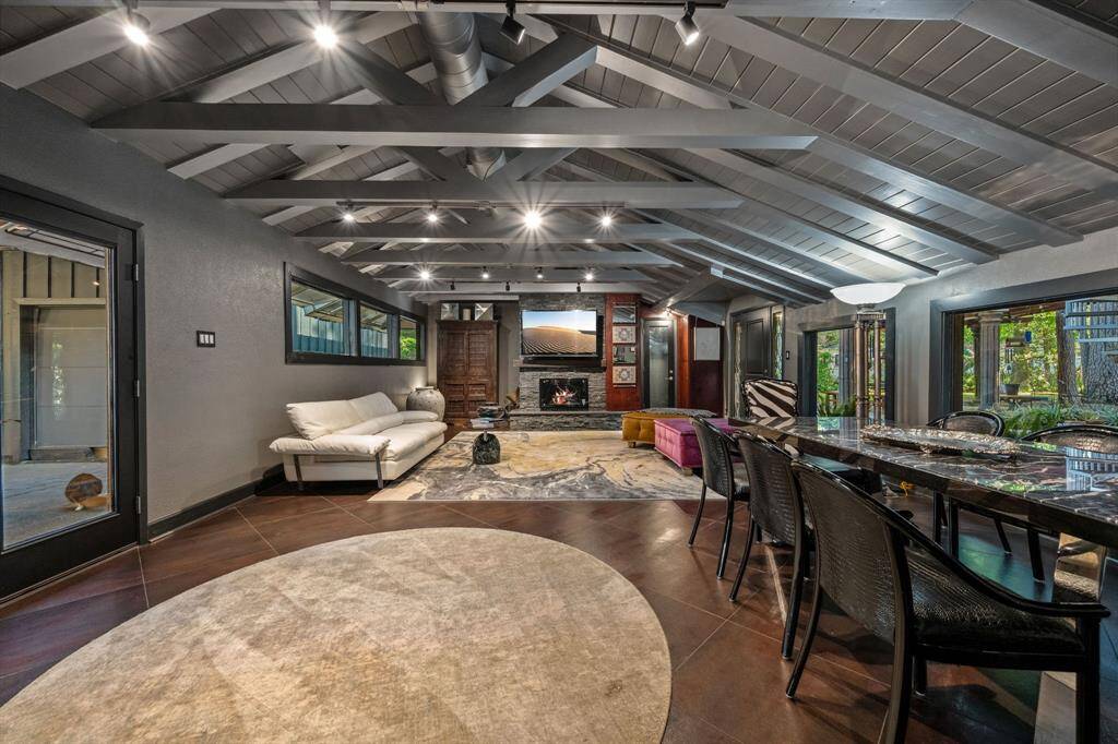 The kitchen offers a beautiful view into the well-lit den, creating an open and inviting atmosphere. With natural light pouring in, the space feels connected, perfect for both cooking and relaxing.