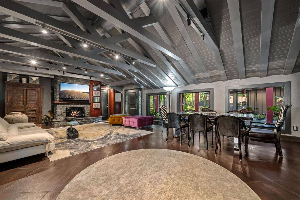 The den, with its adjacent breakfast room, offers serene views of the meticulously maintained courtyard and backyard. The space is bathed in natural light, creating a peaceful and inviting atmosphere for everyday living.