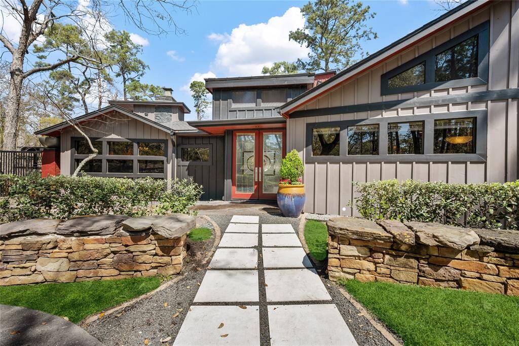 Front walk way with concrete pavers and black rock.