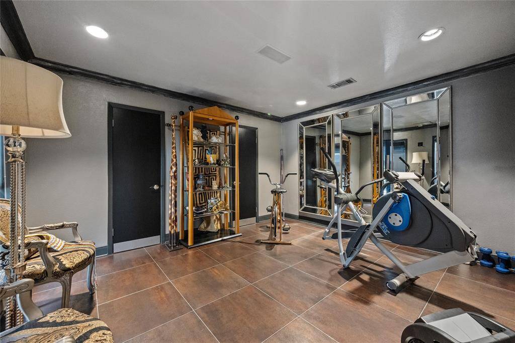 Secondary bedroom currently being used as an exercise room features to large closets.