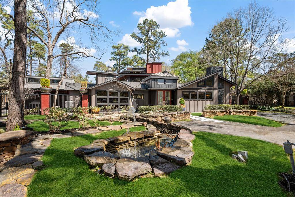 Front of the home is professionally landscaped with with a fountain and pond.