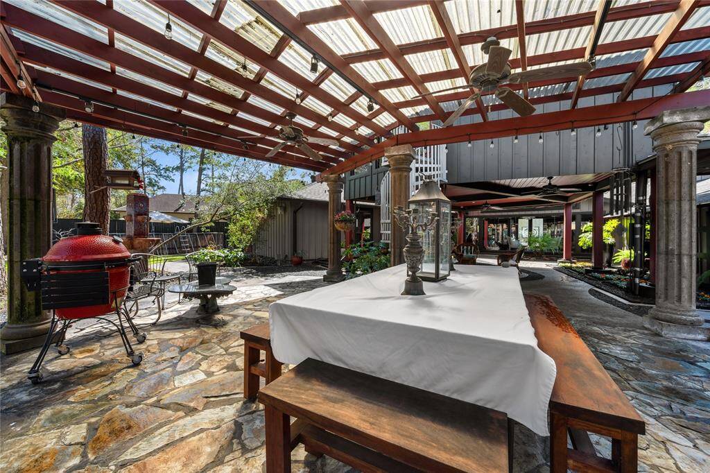 Another shaded space in the backyard is perfect for dining al fresco, offering a cool, comfortable environment surrounded by greenery.
