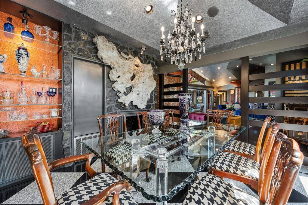 A stunning formal dining room featuring a cozy fireplace, creating a warm and inviting ambiance. Perfect for refined dinners and gatherings, this space blends timeless charm with a graceful atmosphere.