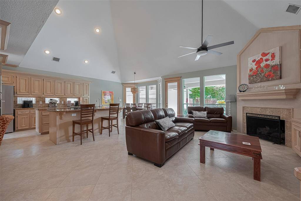 Many homes have island kitchens open to the Den area.  But most will not have the high vaulted ceilings featured here.