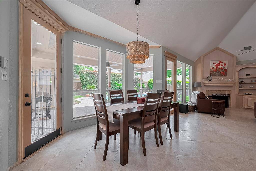 The breakfast area includes a bay window overlooking the backyard and pool.  Diagonal oversized tile floors throughout the kitchen/breakfast/den rooms.