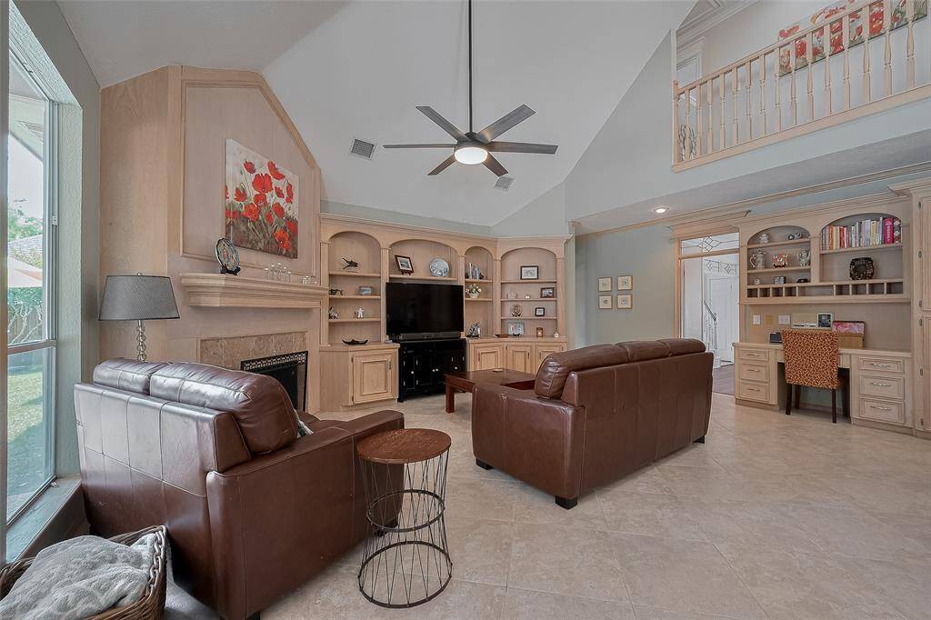 Fireplace, entertainment center and home desk, all custom built.  Catwalk above gives you some idea to the scale in this room.