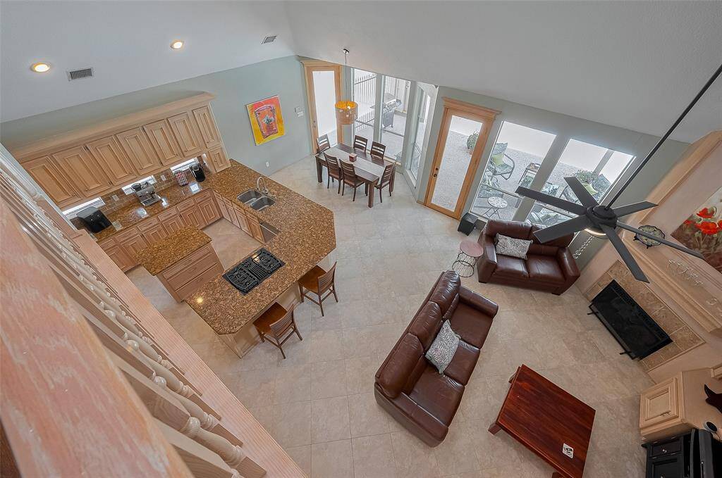 This open island kitchen and den area is so impressive with these high ceilings.