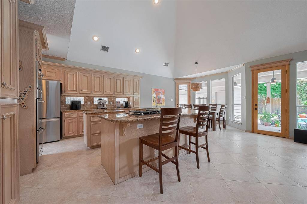 The island kitchen includes hand built wood cabinets, granite countertops and updated appliances.