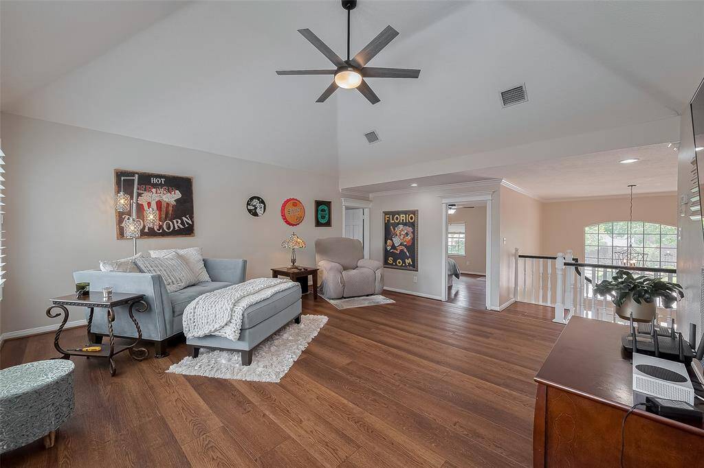 This game room upstairs also includes high ceiling.  Updated ceiling fans here and through most rooms in the home.