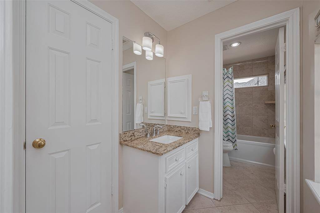 Jack-n-Jill Bathroom #2  Granite countertops, undermounted sinks, diagonal tile floors and updated lighting.
