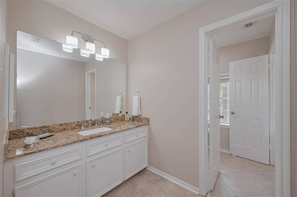 Jack-n-Jill Bathroom #2 Granite countertops, undermounted sinks, diagonal tile floors and updated lighting.