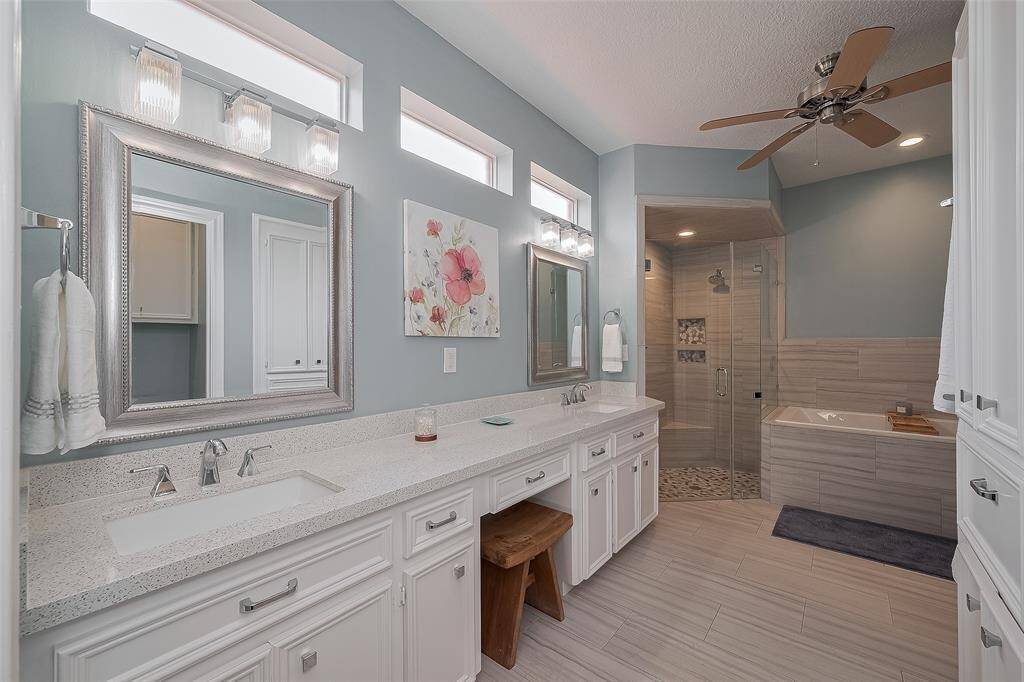 The primary bathroom was updated in 2017.  Frameless shower with updated tile, Quartz counter tops, under mounted sinks, lighting, transom windows and more!