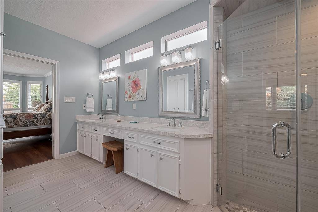 Plenty of space here in the primary bathroom including this oversized vanity with double sinks and quartz countertops.