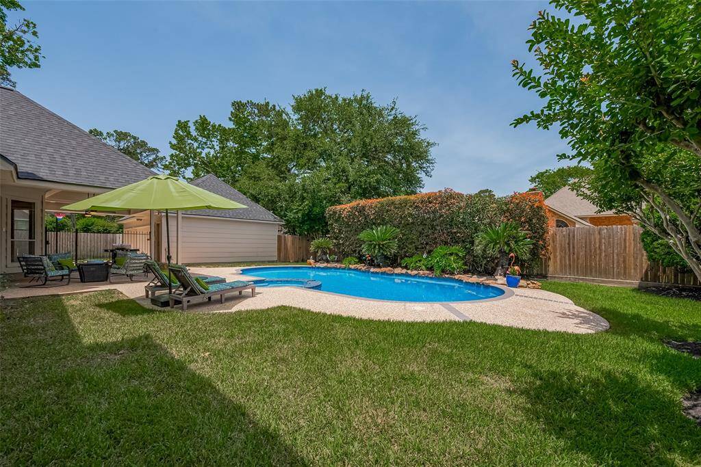 Mature tall hedges and trees provide privacy from neighbors.  Additional grass areas in the backyard for playing on this oversized lot.