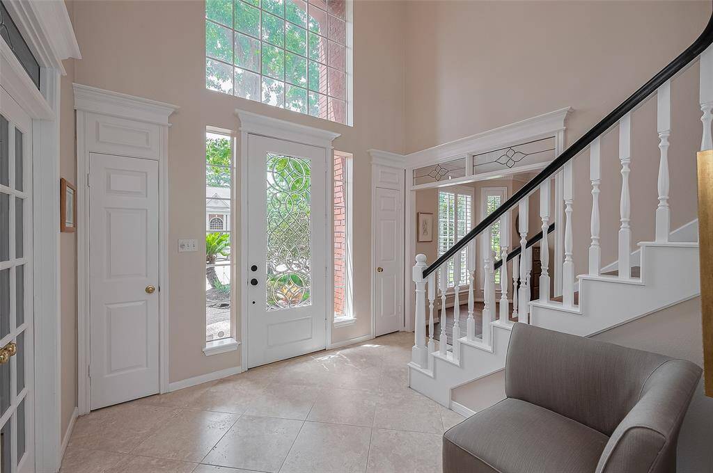 Classic stylilng with crown molding, transom windows above doorways and large divided windows to allow in the natural light.