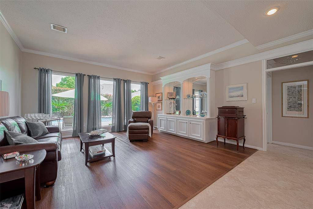 Formal living room include built-ins and large windows overlooking the backyard. Coretec wide 9 inch plank LVP  floors here as well.
