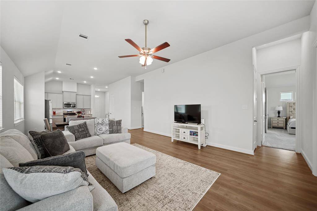 Family Room has a Ceiling Fan, High Ceiling and a perfect spot for Entertainment/TV placement.