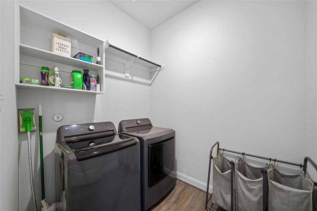 Utility Room has lots of Space with Storage Shelves & Hanging Rod.