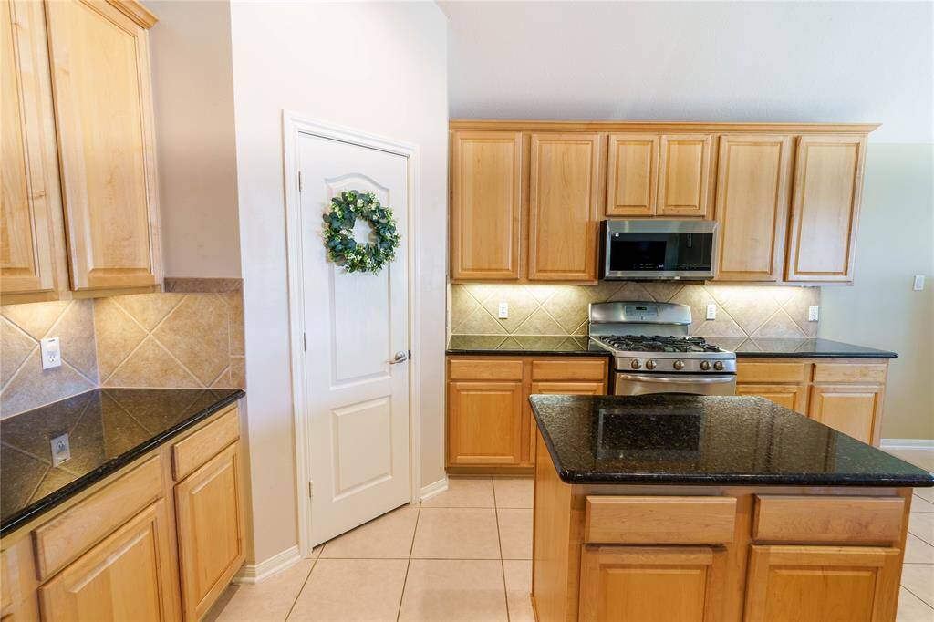 This kitchen has a big pantry and convenient island with extra storage!