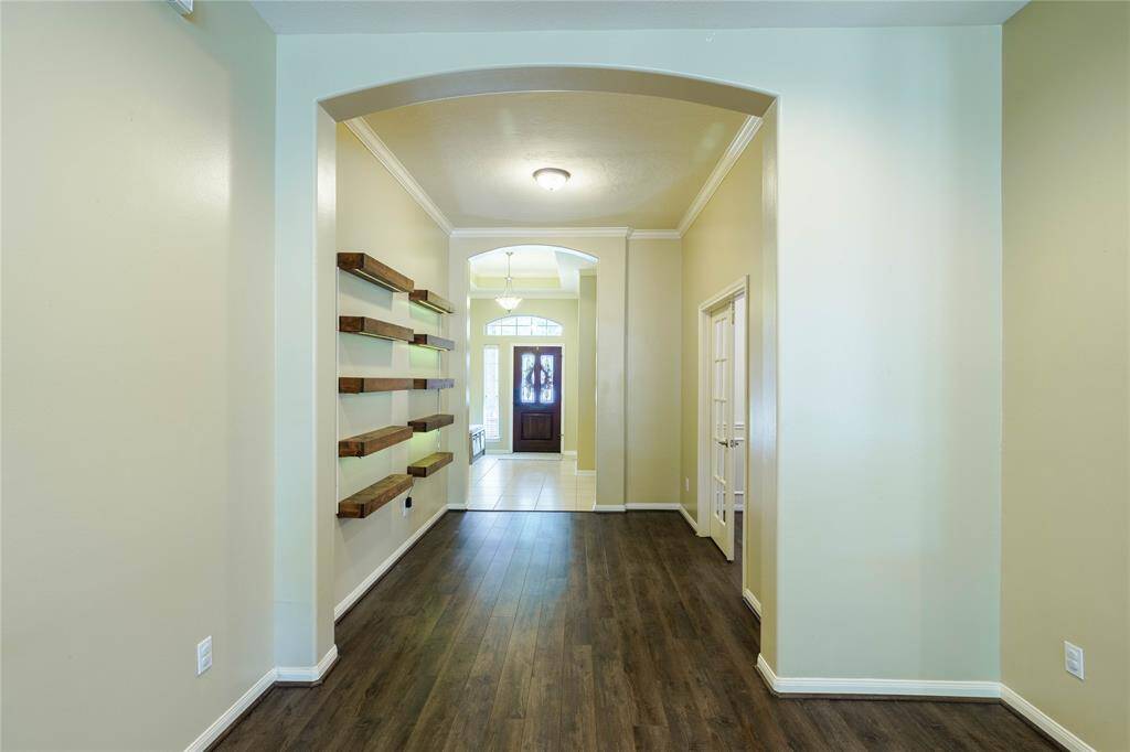 Beautiful archway leads to study/office area.