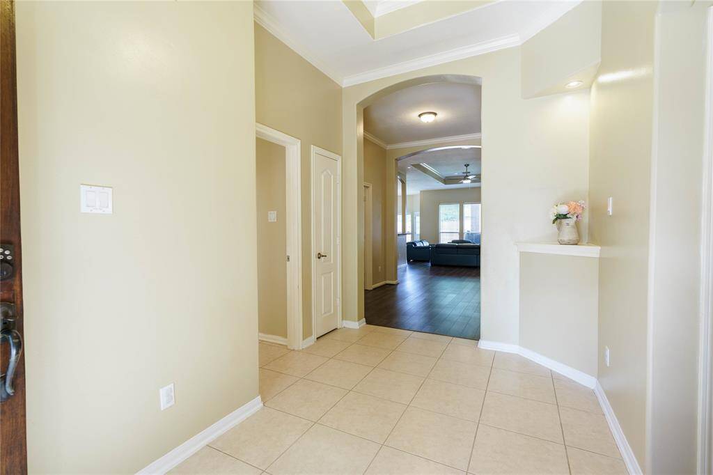 This grand foyer is inviting with a beautiful wall niche!