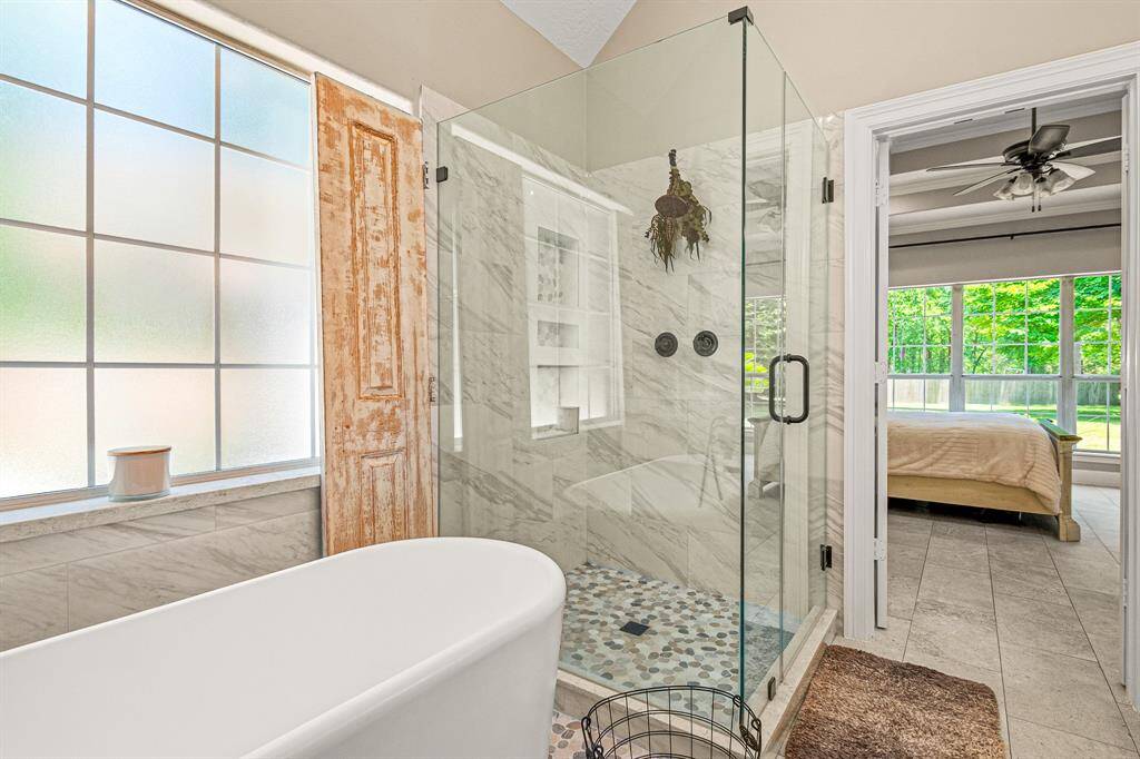This Renovated Primary Bath is a testament to Thoughtful Design!!! Enjoy the large walk-in shower with Pebble Tile Accents or a Long Soaking Bath
