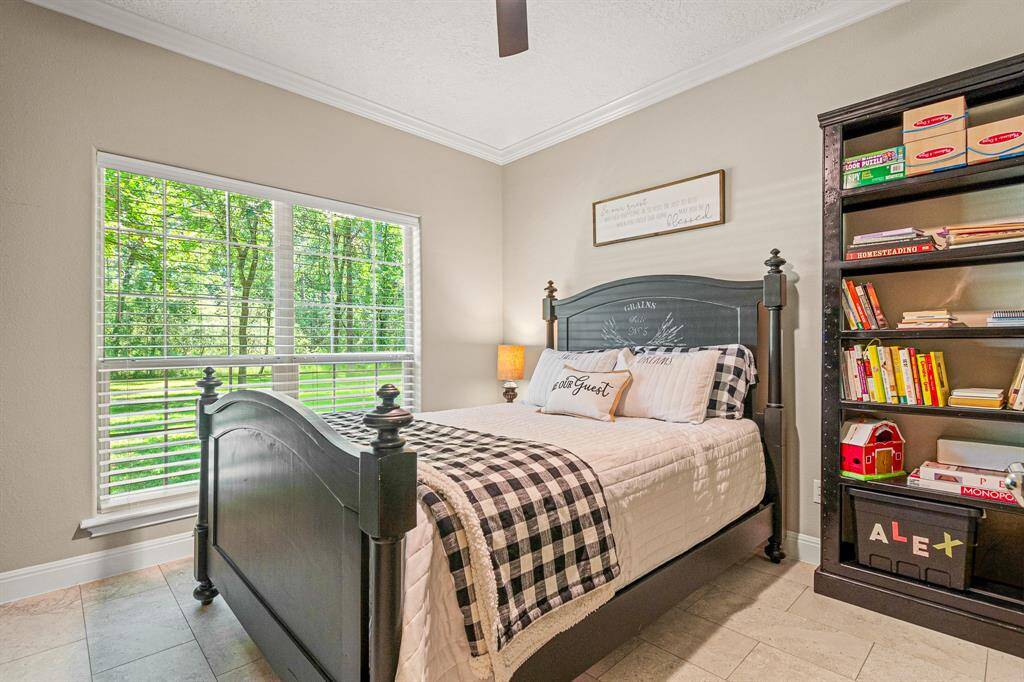Secondary bedroom offers a serene view of the backyard
