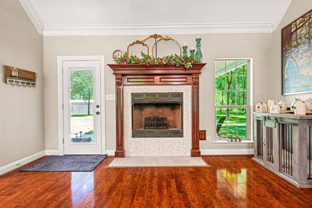 Charming details include updated tile around the fireplace and elegant crown molding.
