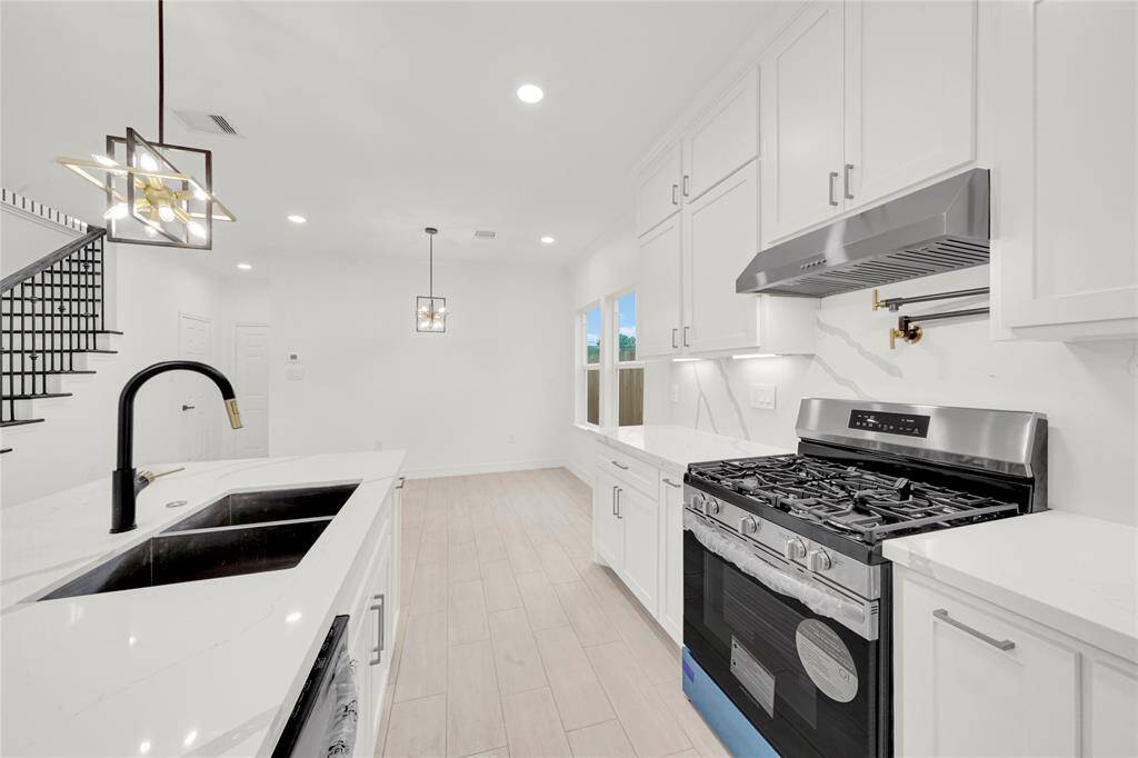 Large kitchen island with sink and bar seating, perfect for gatherings.
