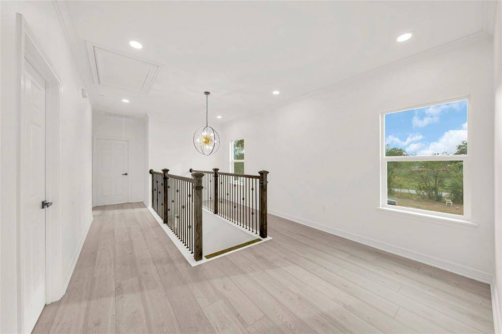 Open upper hallway with natural light and smooth flow between rooms.