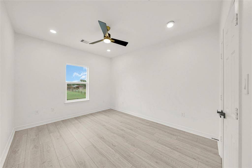 Bright third bedroom with ample space and natural light.