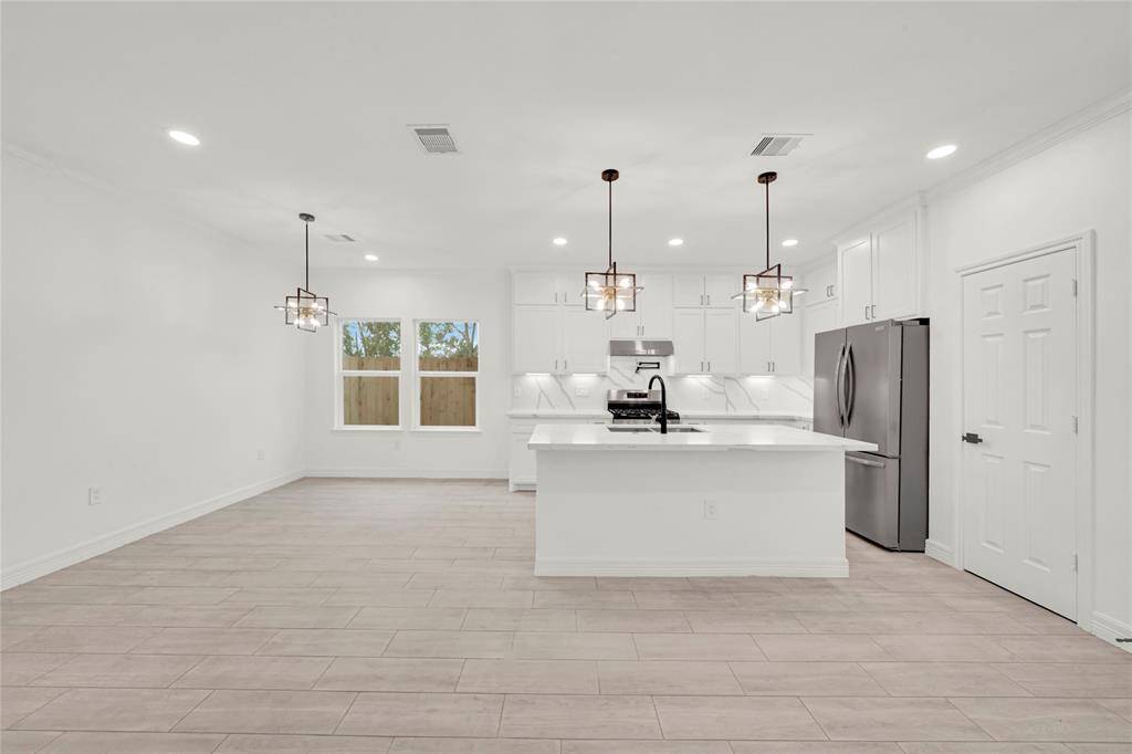 Gourmet kitchen with gas cooktop, quartz countertops, and contemporary finishes.