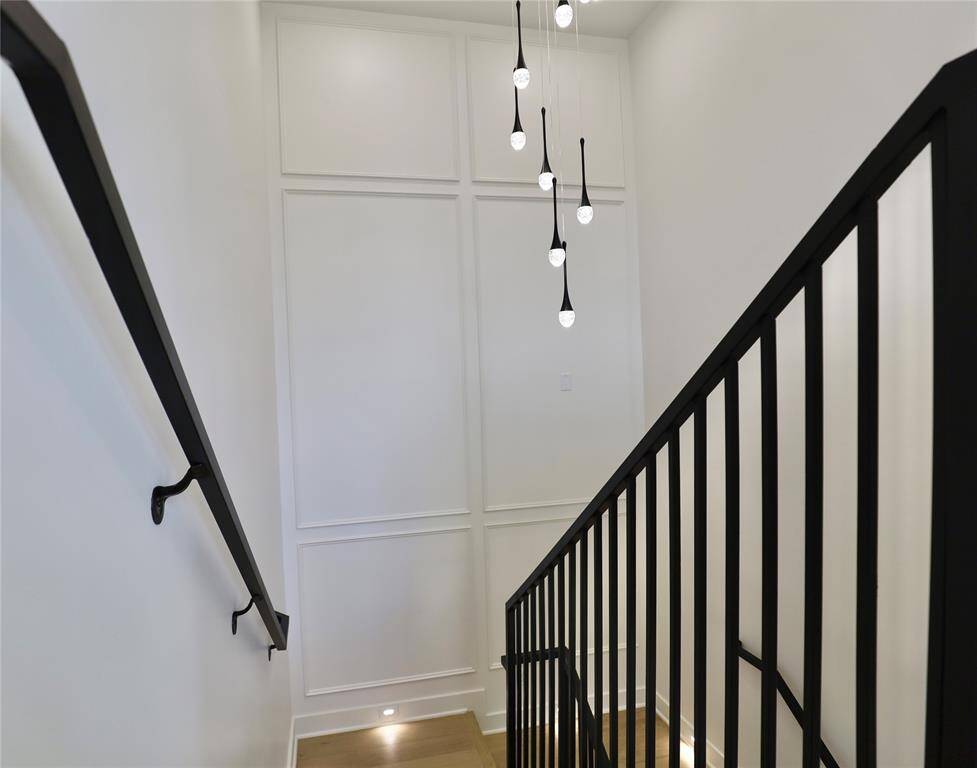 9ft radiant chandelier brightens and adds elegance to the staircase