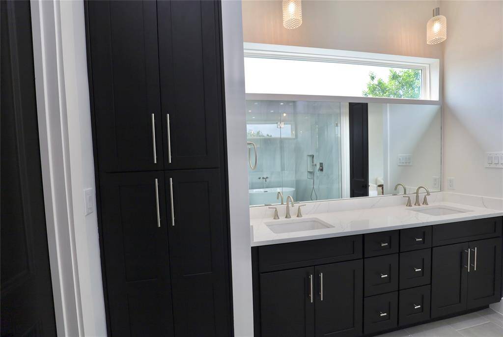 Elevated storage, complete with a linen closet, dual drawer sets, and designer sink faucets — where sophistication meets seamless living.
