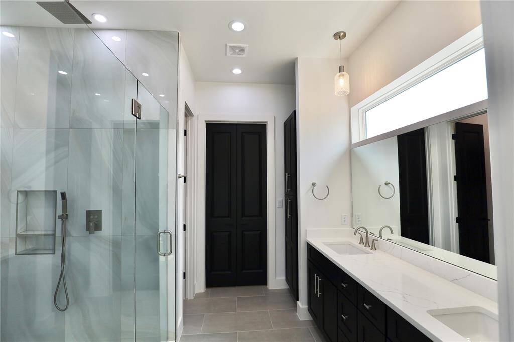 custom designed mirror seamlessly situated above the vanity.