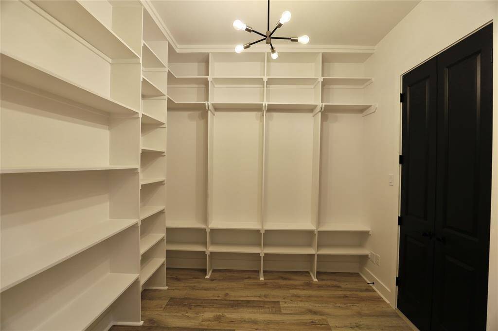 Primary Suite Closet, the shelving area accommodates your cowboy boots showcase your items.