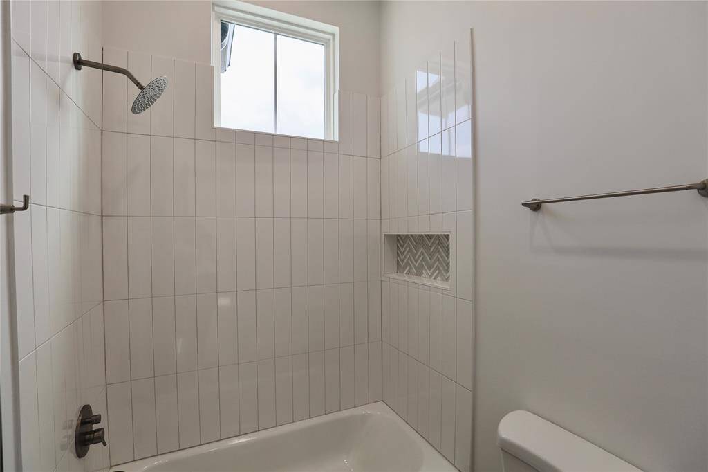 Custom sized shower nook with a towel hanger + hook.