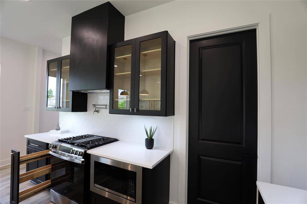 A sleek spice rack beside the range — everything within reach, adding flavor and charm to every dish.