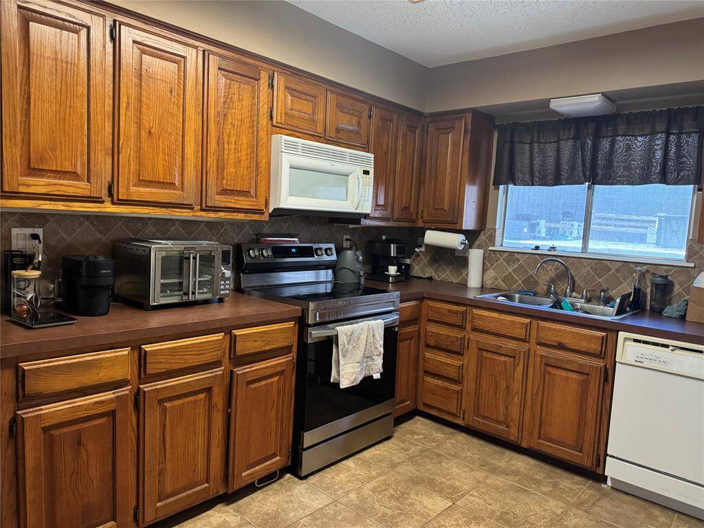 Kitchen with microwave, stove and dishwasher