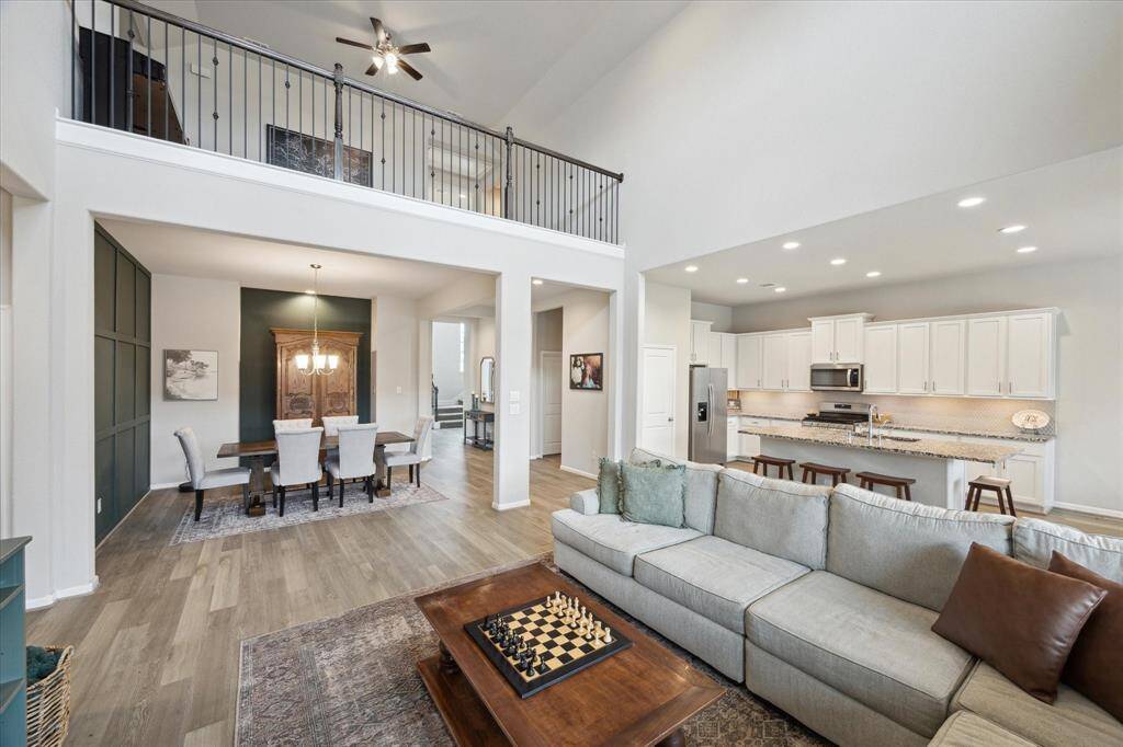 The game room over looks the family area. In this photograph the hall that is located across from the dining room has a full bathroom and a bedroom.  Perfect for those who do not enjoy climbing stairs.