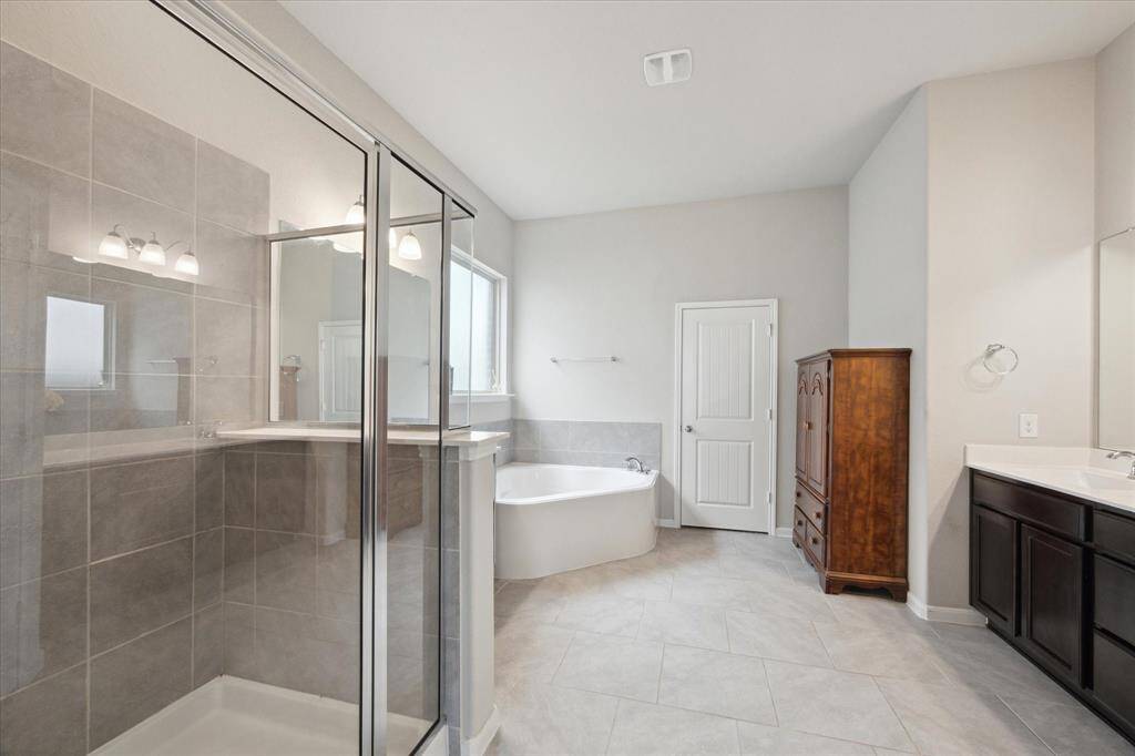 The primary bathroom is a perfect place to soak away the stress from the day.