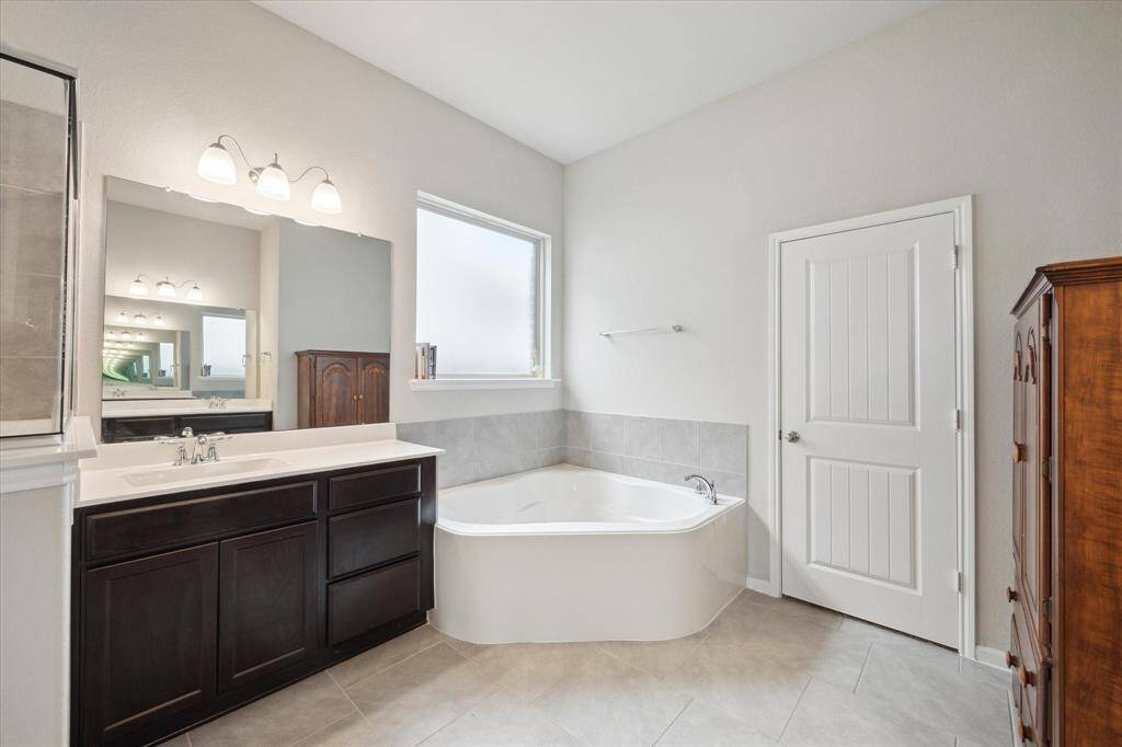 Walk in shower and soaking tub with dual vanities makes getting ready stress free. Closet in located by the soaking tub.