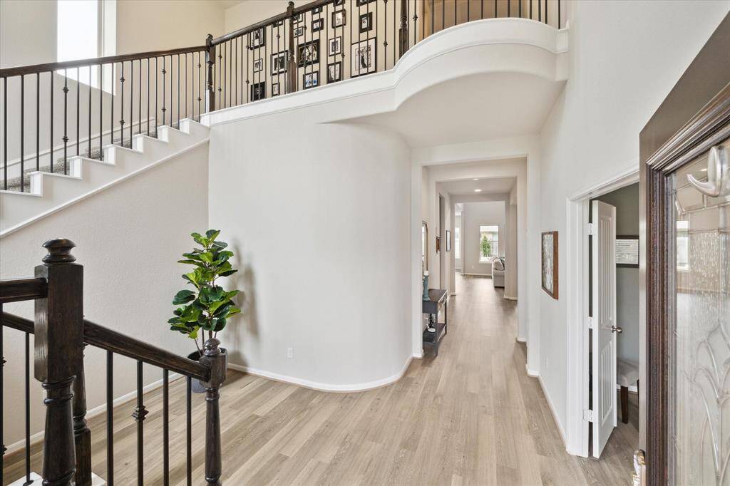 Beautiful grand two story entry with wrought iron railings. Study to your right.