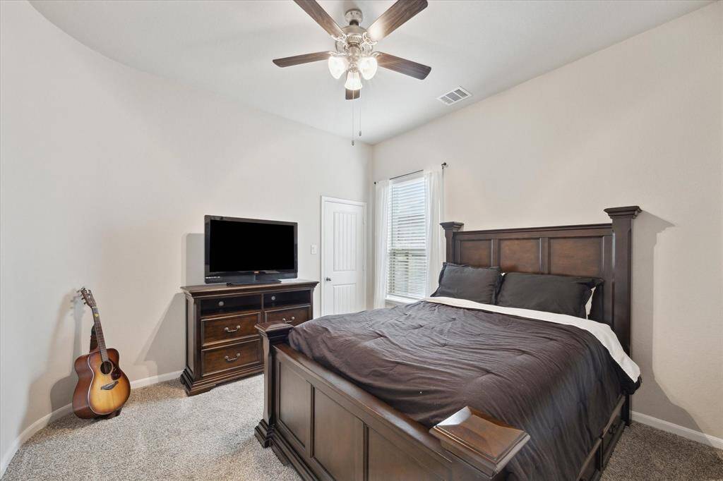 Secondary bedroom with a walk in closet located downstairs