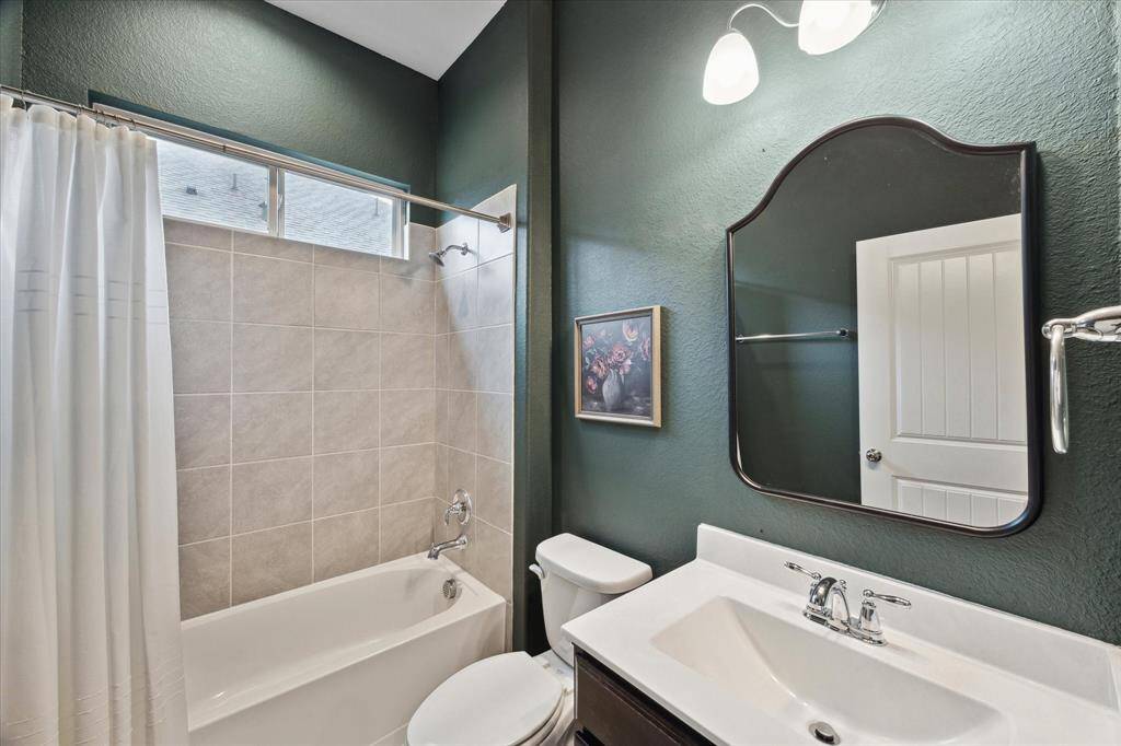 One of the two secondary bathrooms located by the downstairs secondary bedroom.