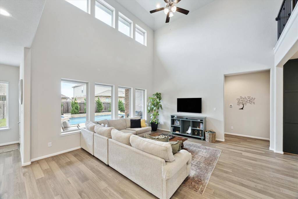 I love the windows with a beautiful view of the pool. Behind the wall where the TV is located is the entrance to the primary suite.